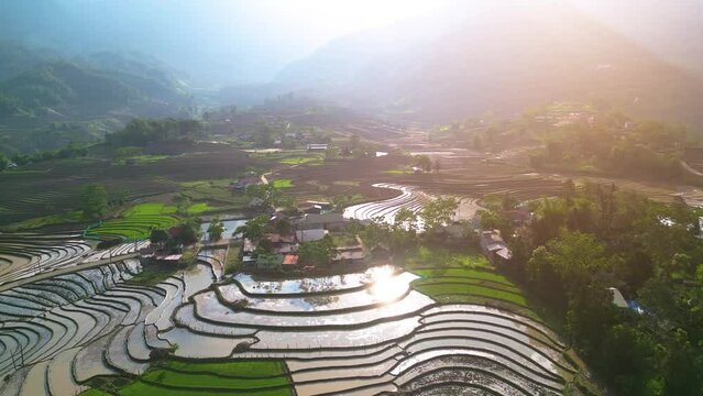 Aerial view of the water season makes the terraced fields of Y Ty commune, Lao Cai province, Vietnam appear with brown soil blending with the beautiful sky.