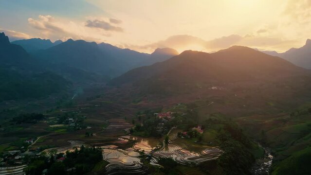 Aerial view of the water season makes the terraced fields of Y Ty commune, Lao Cai province, Vietnam appear with brown soil blending with the beautiful sky.