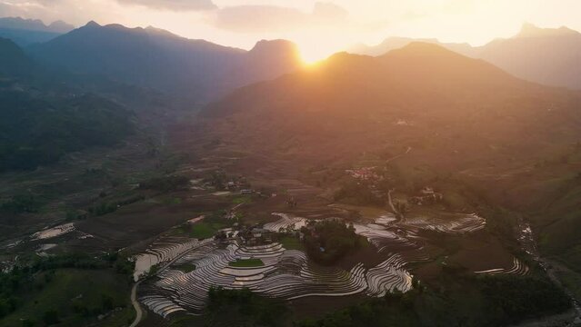 Aerial view of the water season makes the terraced fields of Y Ty commune, Lao Cai province, Vietnam appear with brown soil blending with the beautiful sky.