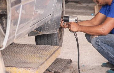 man using wheel removal tool