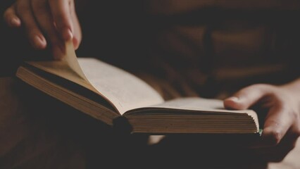 a girl in a vintage dress reads an ancient book at home. female hands turning pages in a book. close up. Woman reading book. - Powered by Adobe