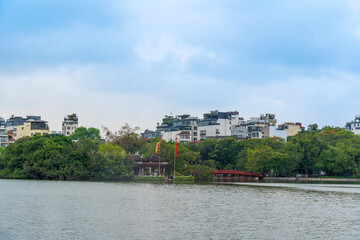 Fototapeta na wymiar view of The Huc Red Bridge and Ngoc Son temple in the center of Hoan Kiem Lake, Ha Noi, Vietnam.