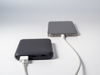 Power bank for charging mobile devices on a white background. Smartphone charger with power supply....