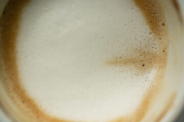 Top view white cup of hot coffee latte art on wood background in restaurant.