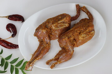 Marinated Quail meat. Quail meat marinated with red chili powder, pepper, ginger garlic paste, salt and lime juice before deep frying