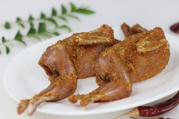Marinated Quail meat. Quail meat marinated with red chili powder, pepper, ginger garlic paste, salt and lime juice before deep frying