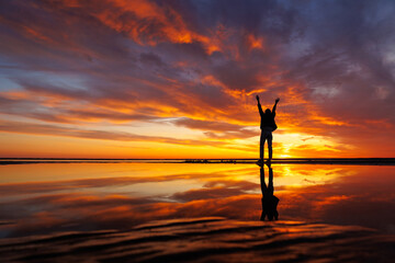 silhouette person against background beautiful sunset sky on ocean, reflection rays sun and sky in...
