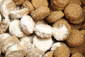 Medication in kibbles or pet food. White powder sprinkled over food for cat or dog. Administer medication, drug treatments, supplements, probiotics or vitamins to animal patients. Selective focus.