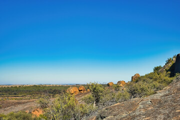 Eroded rocks and boulders with stunted outback vegetation in  Sandford Rocks Nature Reserve, a...