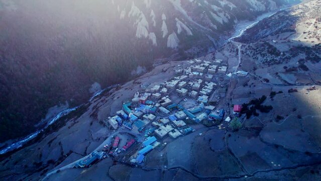 Aerial top down backwards view Khangshar village houses with river stream. Manang district. Tilicho base camp trail. Himalayas mountains. Tourism and Trekking in Himalaya concept.