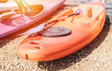 A canoes resting on a lakeshore in the public park on summer days