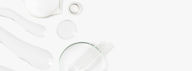 Petri dishes, flasks, test tubes. On a light background. Drops and smears of transparent gel. Laboratory. Banner. empty space for advertising