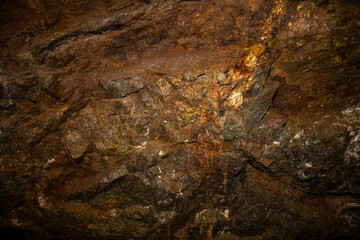 The background wall in the mine, brown in color, has the color of old rust