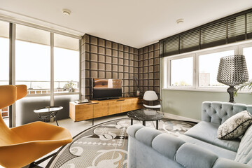 a living room with couches, chairs and a flat screen tv on the wall in the center of the room