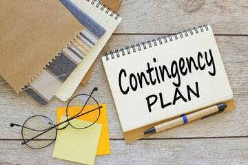 open notebook on the work table. text Contingency Plan