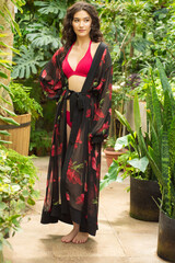 Woman posing in pareo bohemian summer dress near tropic trees
