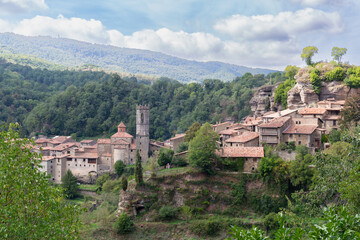 Fototapeta na wymiar Old stone village in a town of Catalonia in Spain. Village in the mountains surrounded by trees