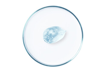 Petri dish with a drop and a smear of a transparent gel or serum on an empty background.