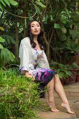 Asian woman posing on tropical background