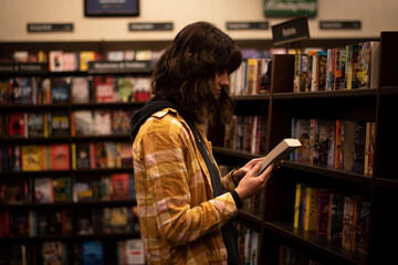 Girl Reading a Book Cover Among Bookshelves