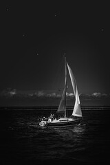 sailboat at night,single sailing yacht at night under the starry sky