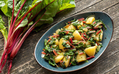 Blitva dish made with boiled potatoes, Swiss chard, garlic and olive oil. Fresh beet leaves on...