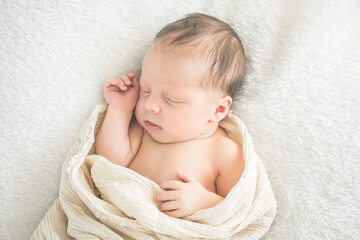 Cute baby sleeping 5 days old on light blanket. Banner design with space for text