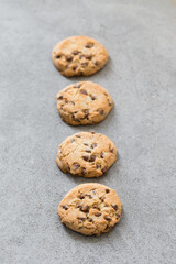 Cookies with pieces of milk chocolate. Light grey background