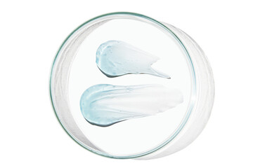 Petri dish with a drop and a smear of a transparent gel or serum on an empty background.