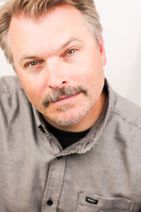 Fototapeta premium Middle Aged Man Close Up Head Shot Grey Shirt