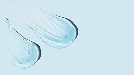 Drops and smears of a transparent gel or serum on a blue background. Banner with empty space for advertising.