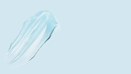 Drops and smears of a transparent gel or serum on a blue background. Banner with empty space for...