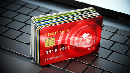 Credit cards standing on laptop computer keyboard. 3D illustration