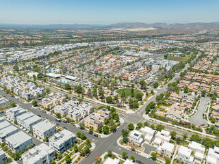 Irvine, California - July 1, 2023: Aerial drone photo above Irvine Great Park Village in Irvine for new townhouses, townhomes, homes, houses, with Great Park Blvd, Parasol Park, Single Dogs Trail, Bea