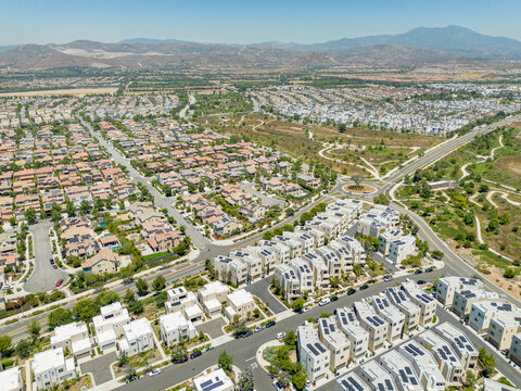 Irvine, California - July 1, 2023: Aerial drone photo above Irvine Great Park Village in Irvine for new townhouses, townhomes, homes, houses, with Great Park Blvd, Parasol Park, Single Dogs Trail, Bea