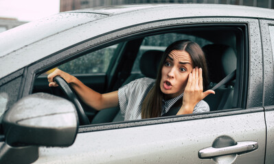 Traffic jam. Aggressive driver. Car accident. Close up portrait displeased angry woman driving car...