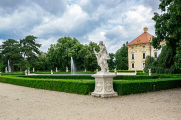 Sculptures in the park and the main building of Castle Slavkov (Austerlitz), Czech Republic.