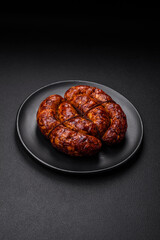 Delicious grilled sausage in the form of a ring with salt, spices and herbs