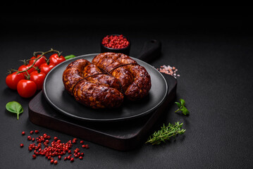 Delicious grilled sausage in the form of a ring with salt, spices and herbs