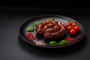 Delicious grilled sausage in the form of a ring with salt, spices and herbs