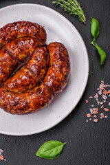 Delicious grilled sausage in the form of a ring with salt, spices and herbs