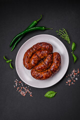 Delicious grilled sausage in the form of a ring with salt, spices and herbs
