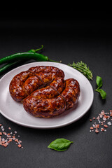 Delicious grilled sausage in the form of a ring with salt, spices and herbs