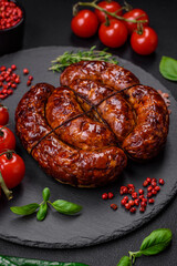 Delicious grilled sausage in the form of a ring with salt, spices and herbs