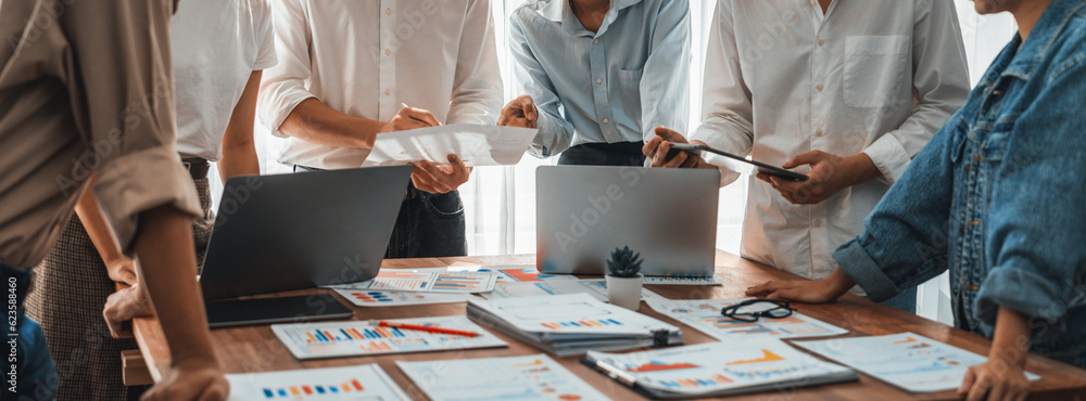 Poster Analyst team utilizing BI Fintech to analyze and pointing at financial dashboard paper office. Businesspeople examining report paper on table for business insight. Panorama shot. Scrutinize