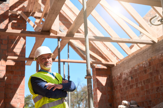 Confident man building constructor standing with folded on chest hands