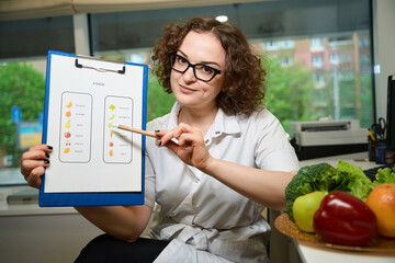 Female demonstrates visual aid with nutritional characteristics of vegetables