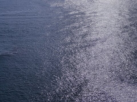 Sea water seascape glittering surface blue silver at night.