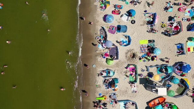 Aerial landscape of crowded beach and sea during summertime