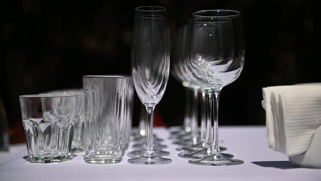 Beautiful luxury empty crystal glasses stand on the table against the background of the sun rays